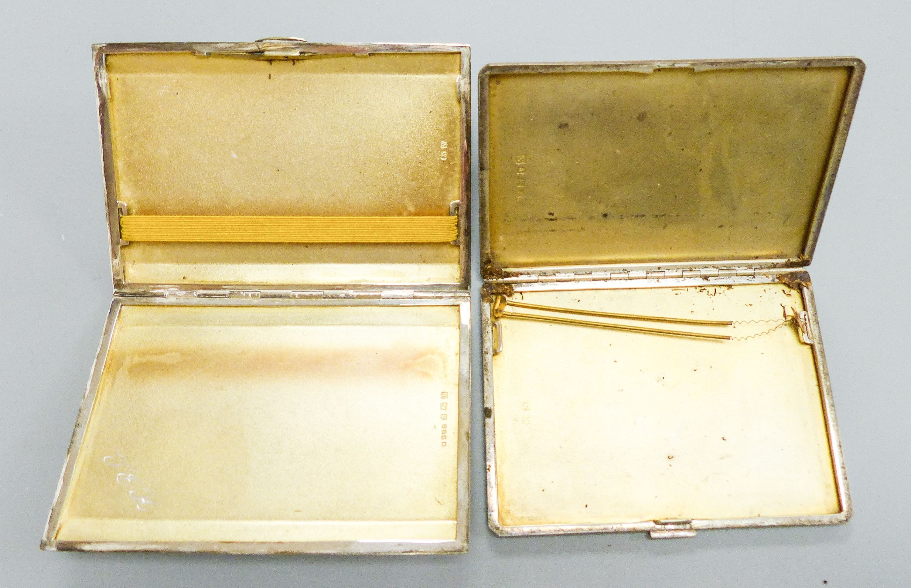 Two George V engine turned silver cigarette cases, largest 12.4cm, gross 12.5oz.